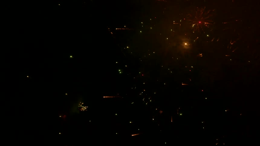A view of some fireworks exploding at night