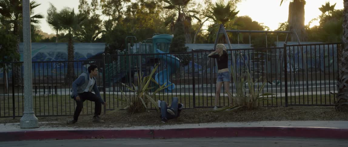 A man is assaulted while a worried woman stands nearby
