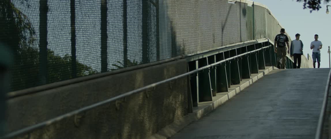 A man with a backpack walks up a ramp