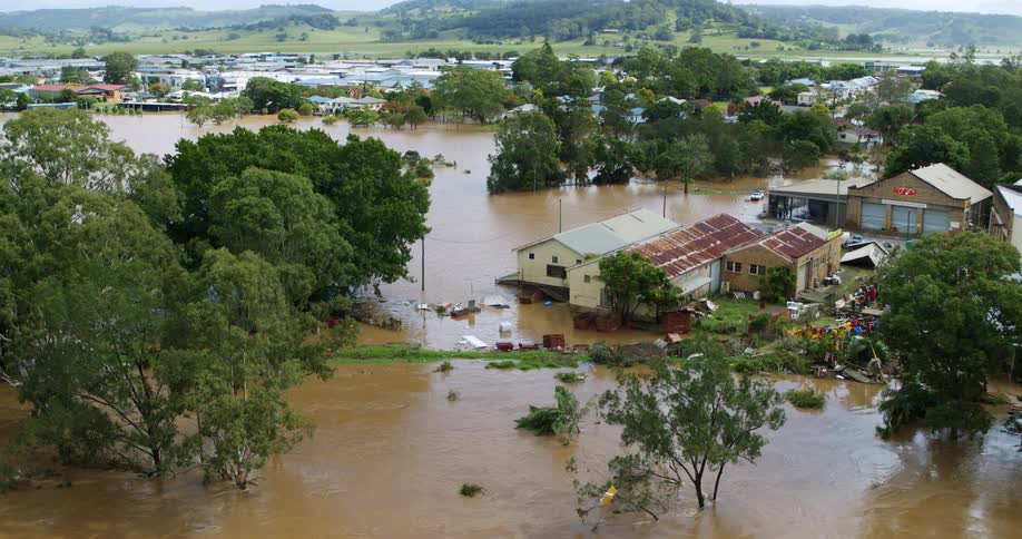 Rural city devastated by flooding waters surrounded by hills outdoors during day time
