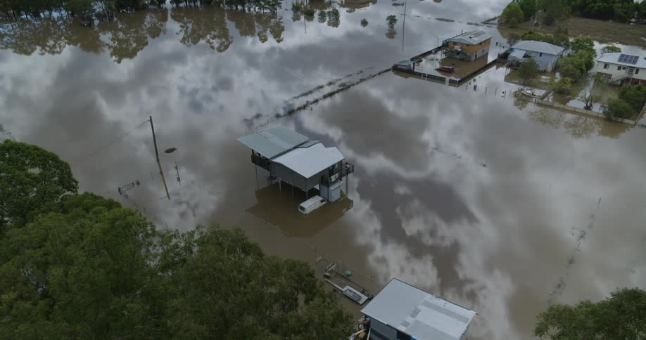 An aerial view of houses in a city that have been flooded