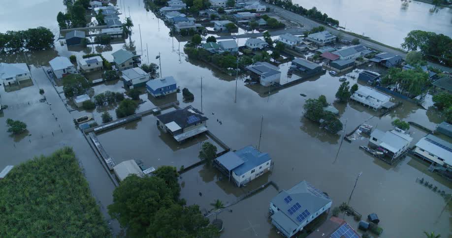 Aerial view of a flooded neighborhood with homes and streets submerged in water