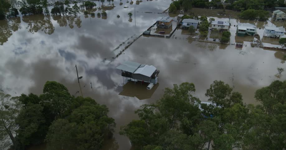 Houses in a rural neighborhood covered in waters from a flood outdoors during day time