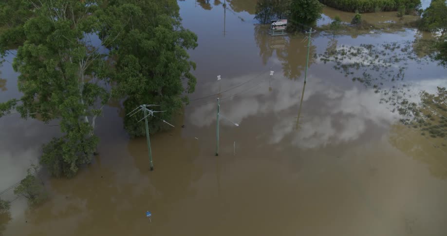 Urban flooded area covered in water with trees around outdoors during day time