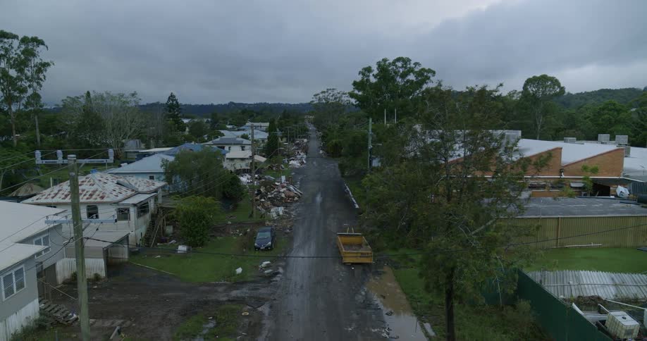 A residential neighborhood is damaged by flooding and storms