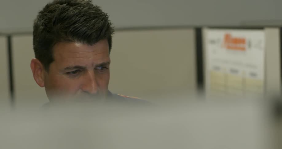 A man smiles as he works