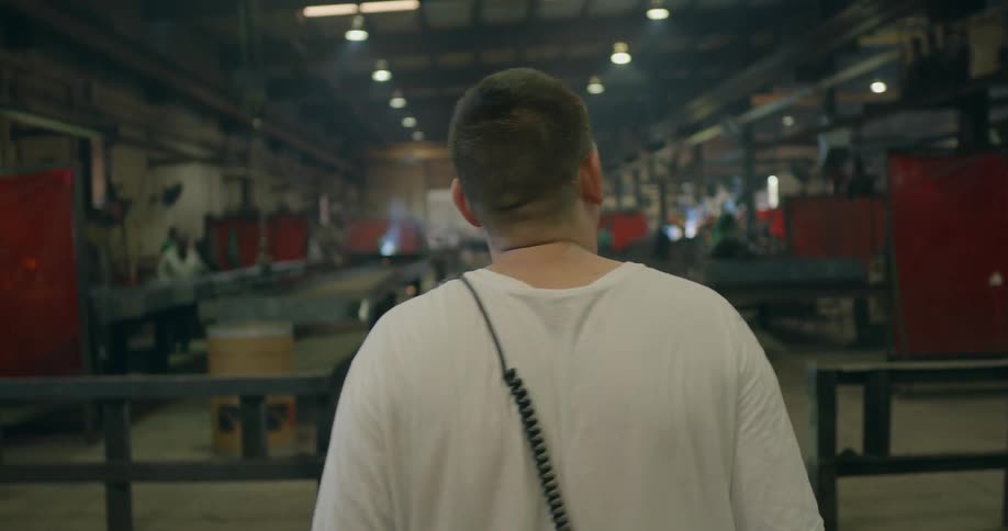 A man walks through a busy shop