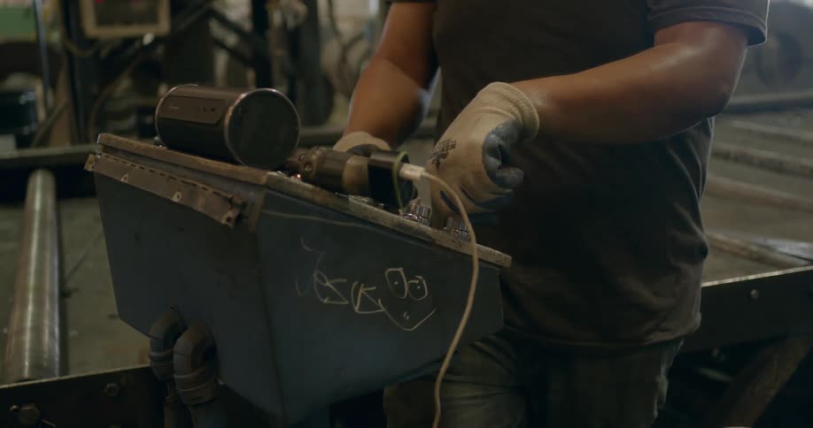 A man is working in a shop sweating