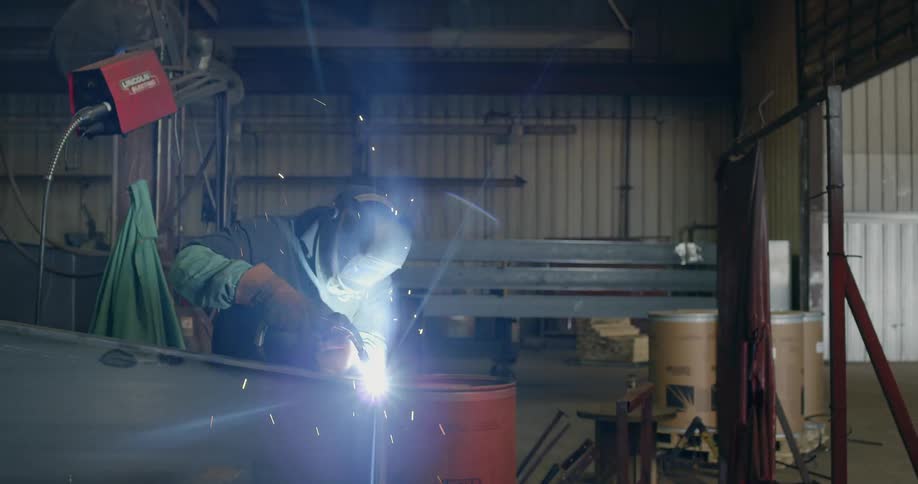 Man welds on a piece of metal