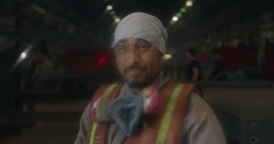 Man taking off gas mask and smiles