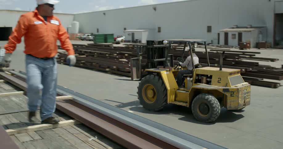 A forklift drives past a work site