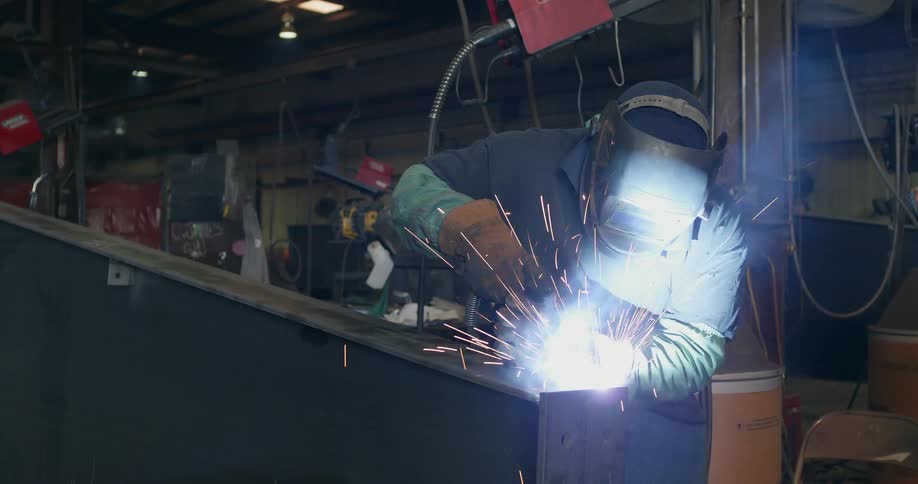 A welder works in a factory