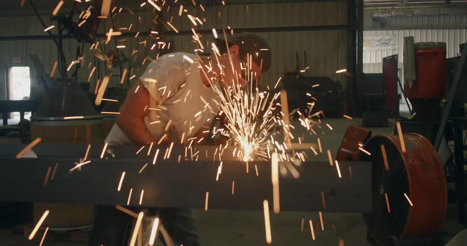 Sparks fly as a worker welds a beam
