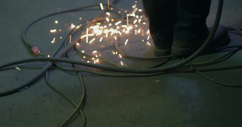 Sparks fall on the floor as a person works