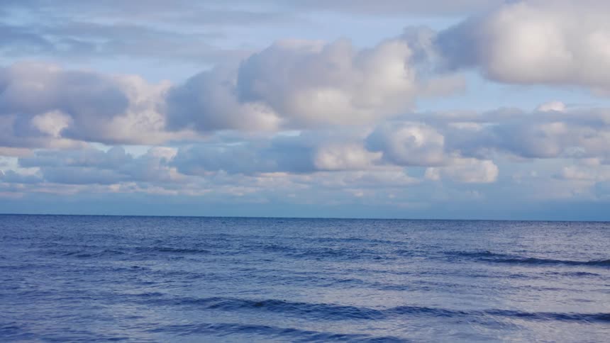 Blue sky with clouds over the ocean outdoors during dusk or dawn