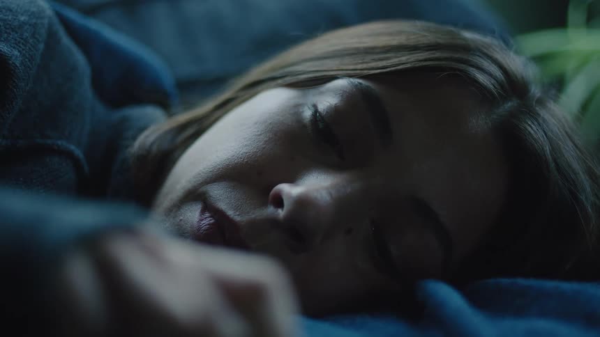 Woman lying on someones chest on the couch