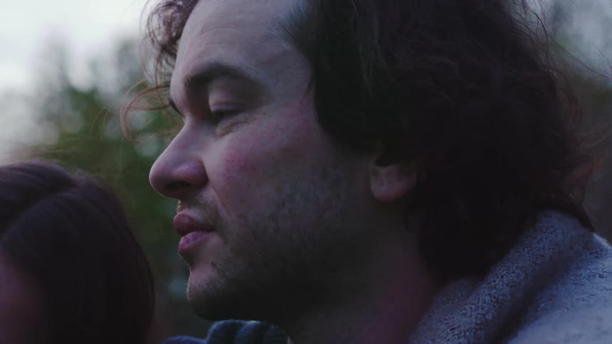 A woman leaning back onto a man