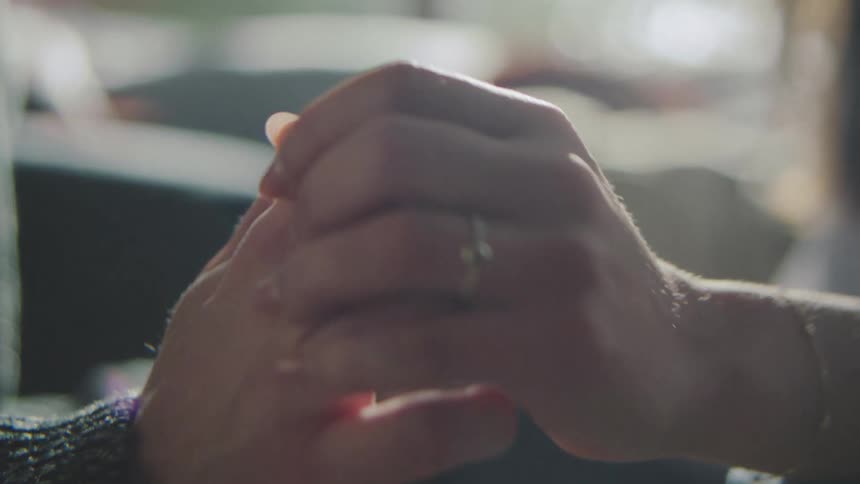 Male and female hands holding and caressing each other during day time
