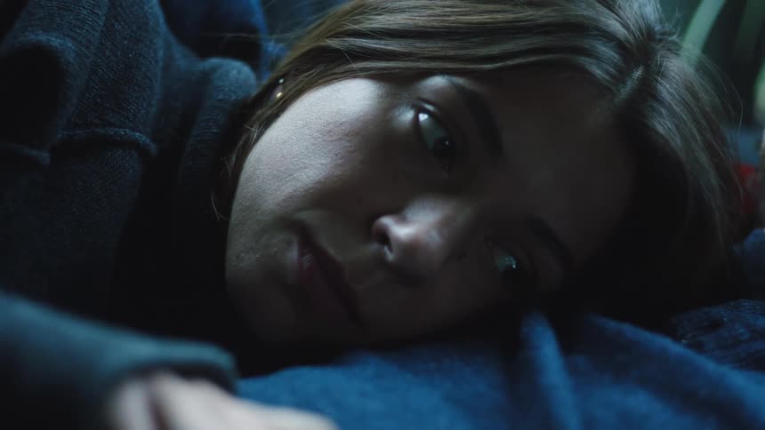 Woman talks while lying with her head on a mans chest