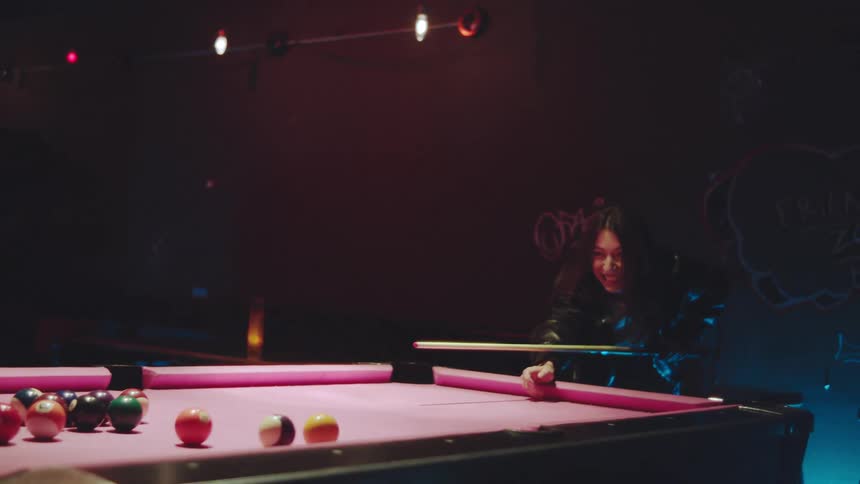 A man and woman playing pool