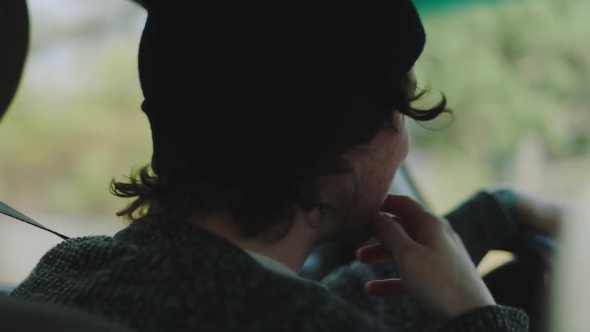 The man smiles while he drives