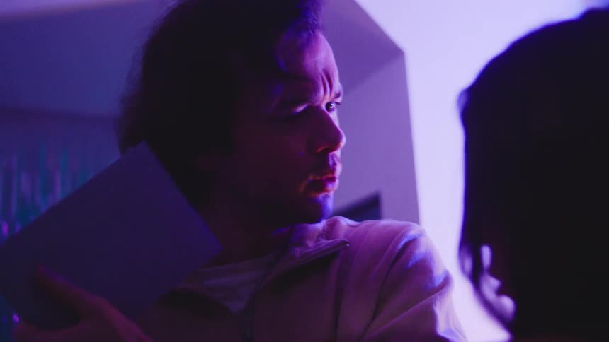 A man and woman talking in a room