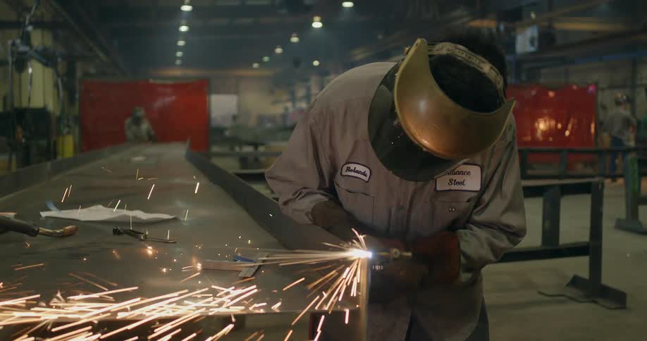A welder works in a steel factory