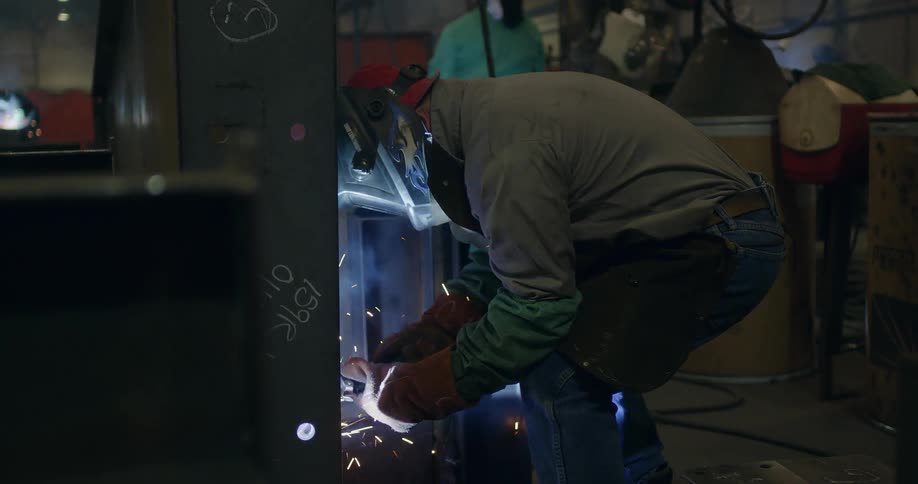 Man welds a piece of metal