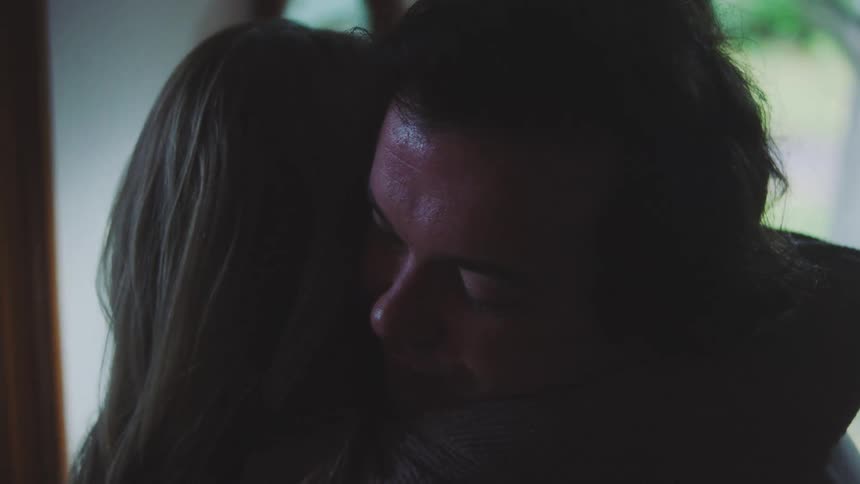A man and woman hugging each other