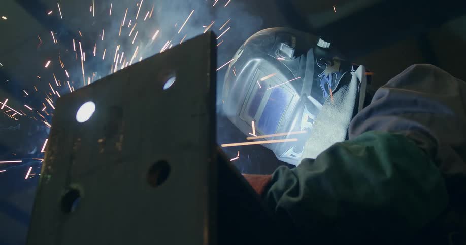 A welder works in a factory