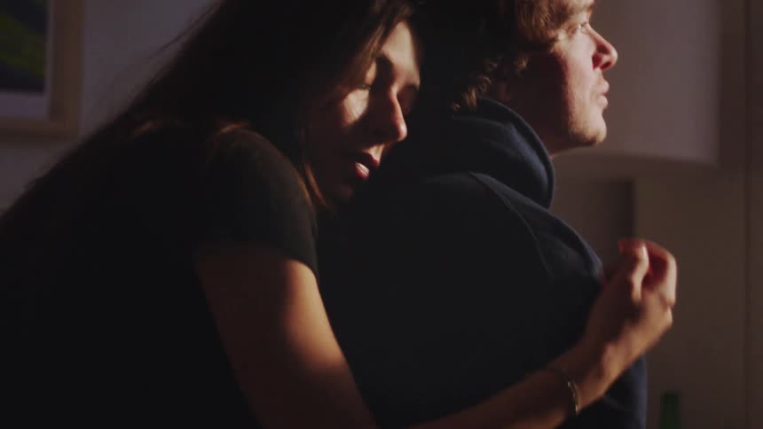 A woman hugging a man from behind