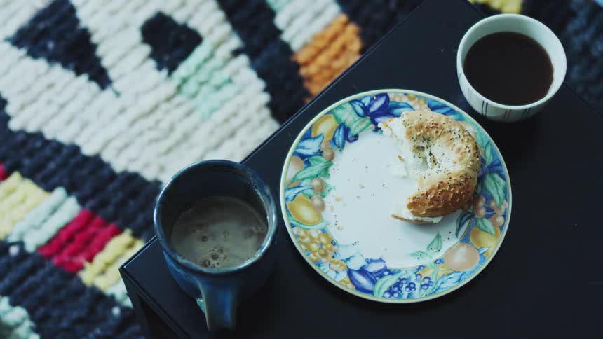 The plate and two cups is sitting on the black table