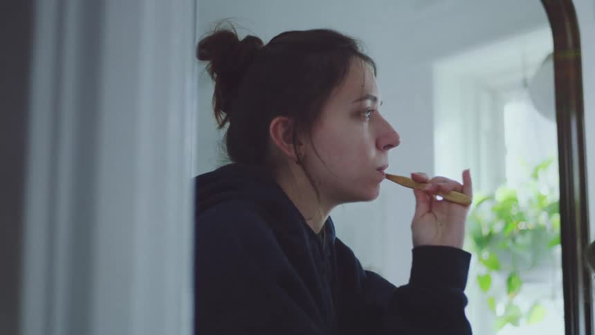 The couple brush their teeth in the bathroom