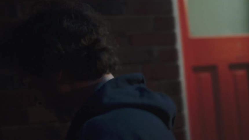 The man knocks on the door and another man answers it