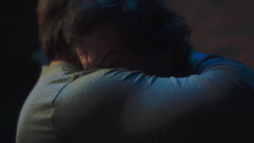The man begins crying and is hugged