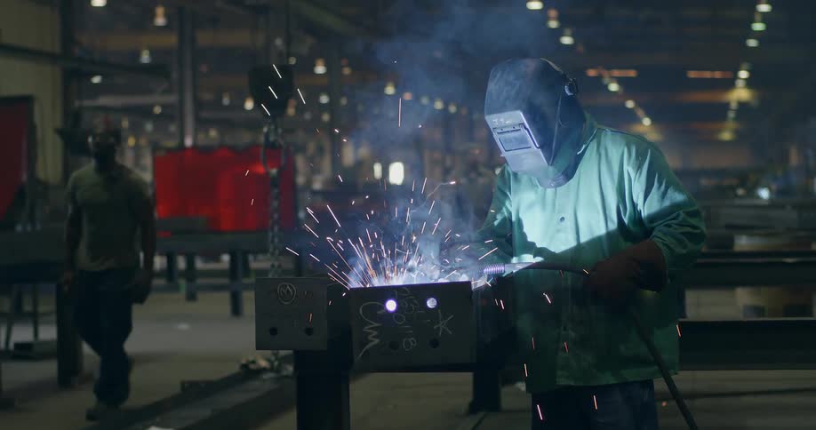 A welder works in a factory