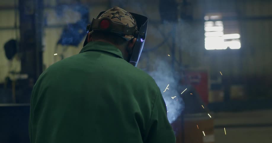 Sparks flying as a welder works with a torch