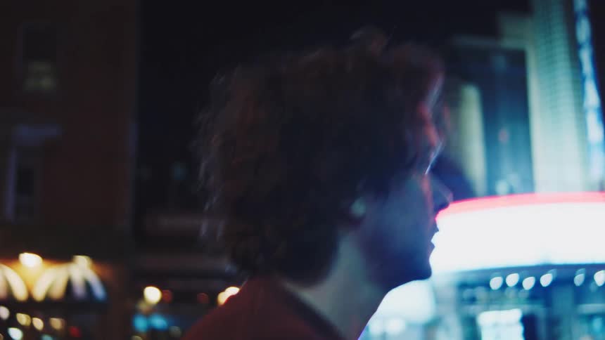 A man walking in a city at night