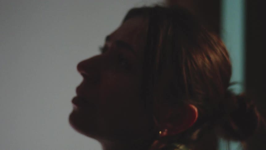 Woman crying in front of another person indoors