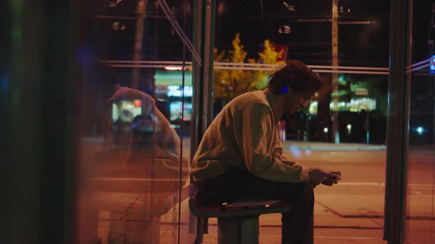 A man sitting on a bench outdoors