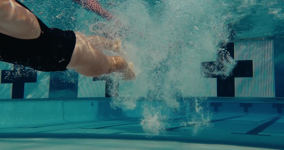 A woman diving and swimming in a pool