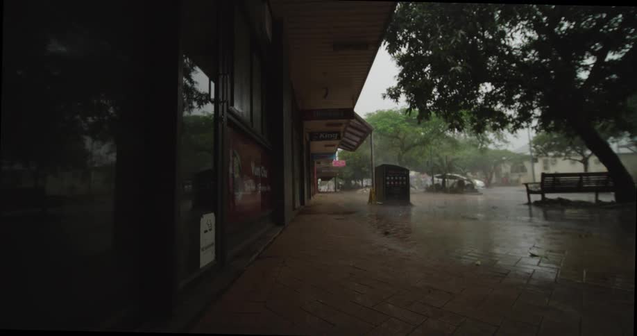 A view of buildings next to a street on a rainy day