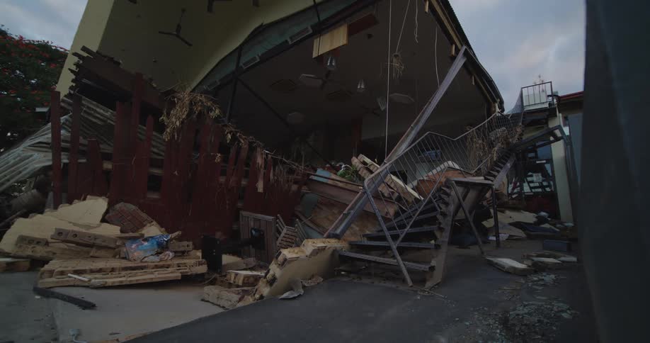 Exterior of a destroyed building in a suburban city during daytime
