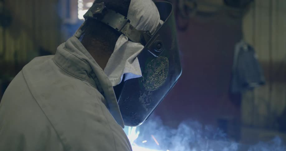 A man is welding in a shop
