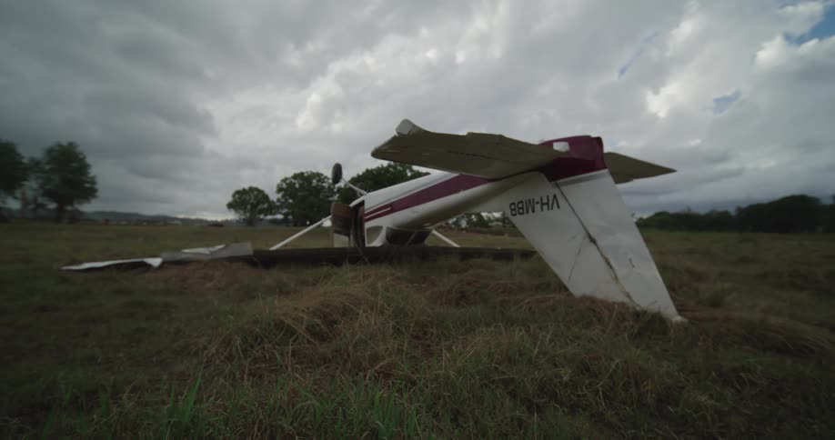 Wrecked small airplane lying upside down in a field