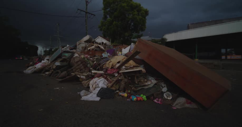 Trash and broken furniture on the streets of an urban area outdoors