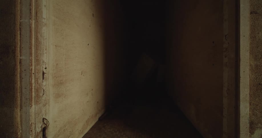 A dark corridor in an uncompleted building during daytime