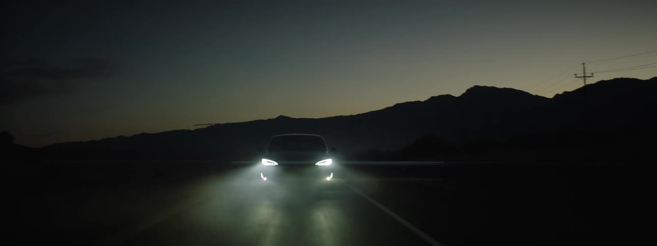 Car turns headlights on while driving on highway at night