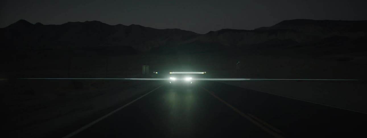 Car traveling on mountain highway at night