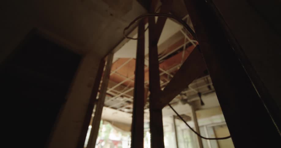 Interior structure of a building with damaged walls exposed beams and visible wiring
